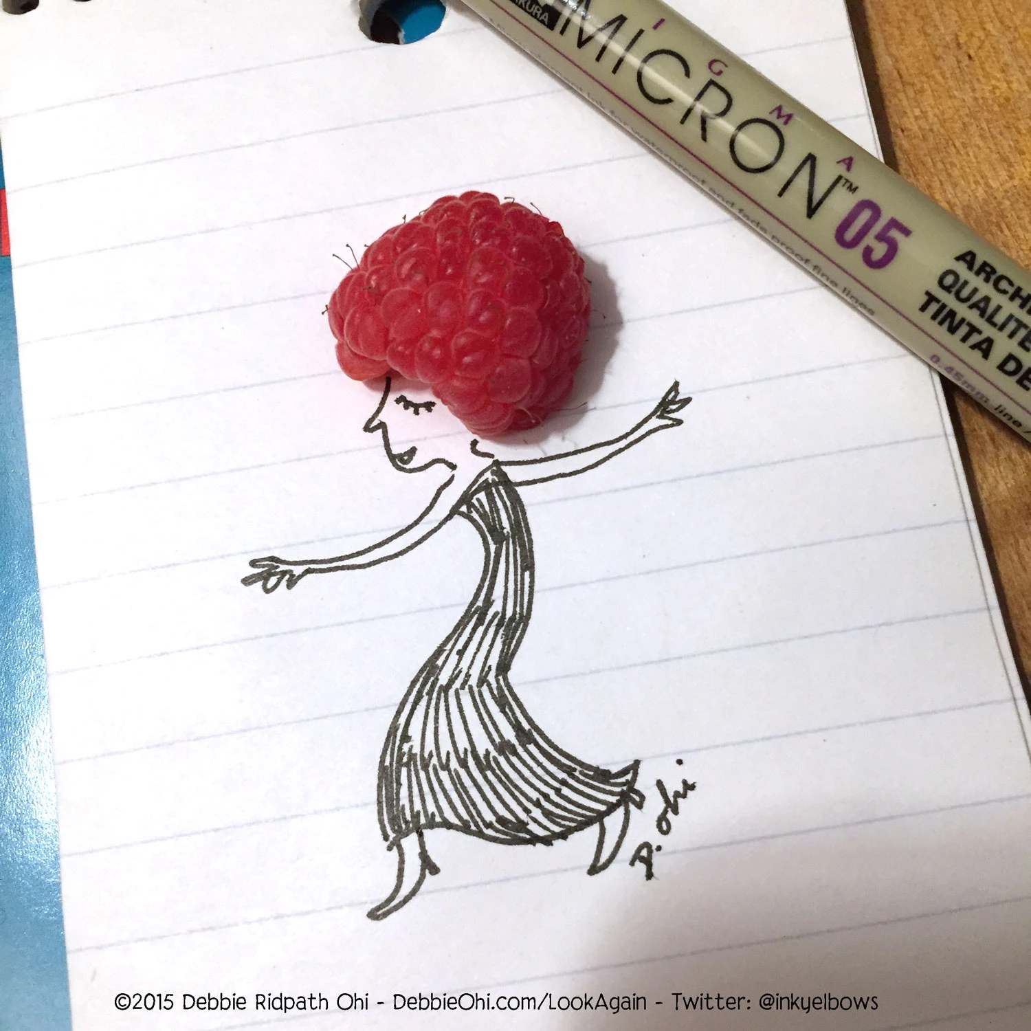 Found object art featuring a raspberry that has been incorporated into a dancing woman's headpiece