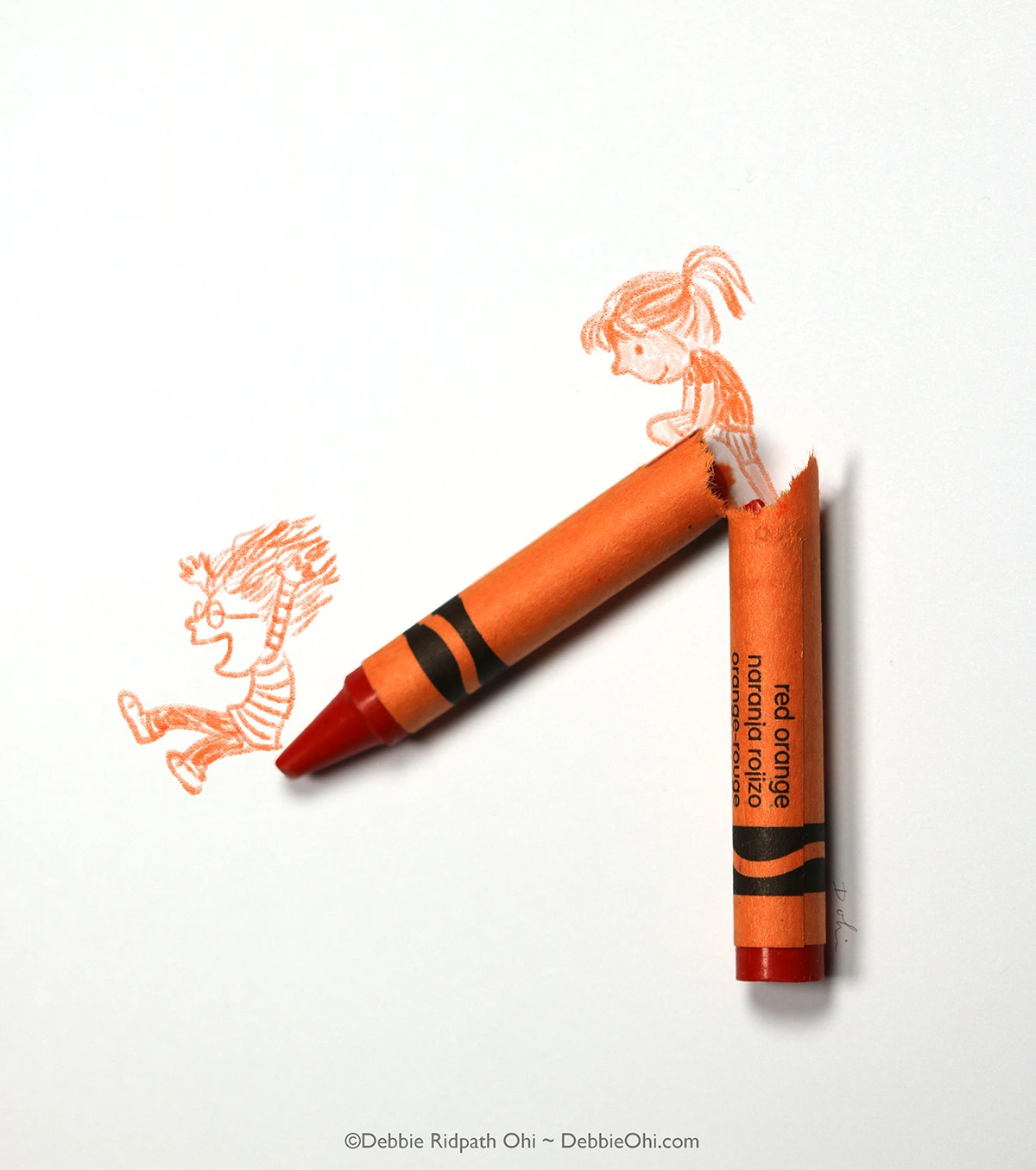 Broken art art with an orange crayon with two children happily sliding down like it's a playground slide