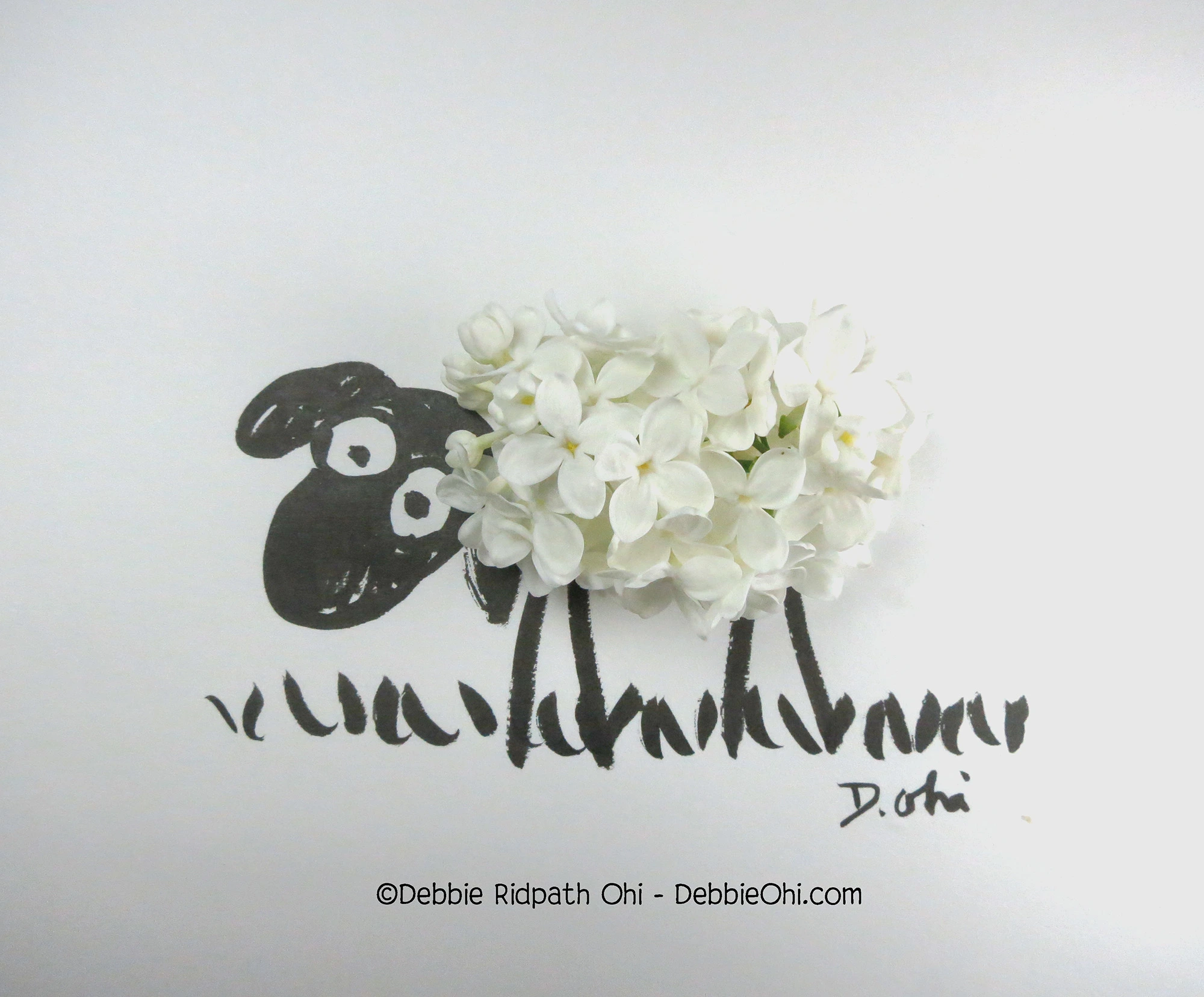 Found object art featuring a sheep made out of a white lilac blossom.